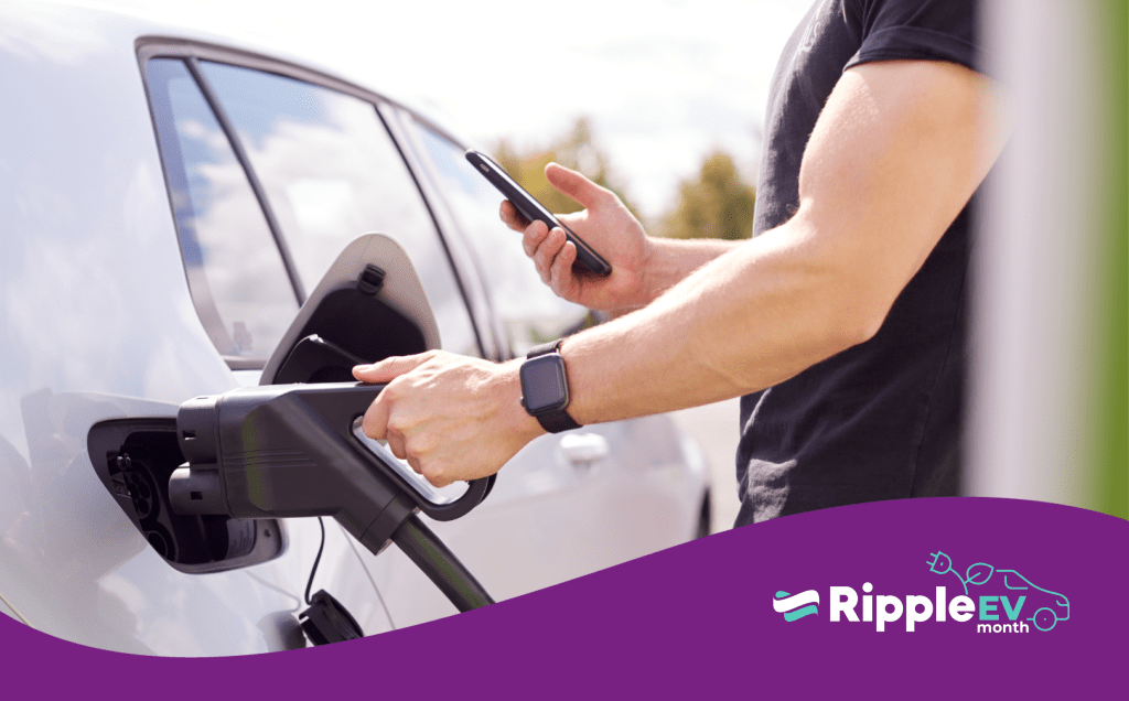 Man charging his electric vehicle holding a phone. Ripple EV logo with a purple wave along the bottom of the image.
