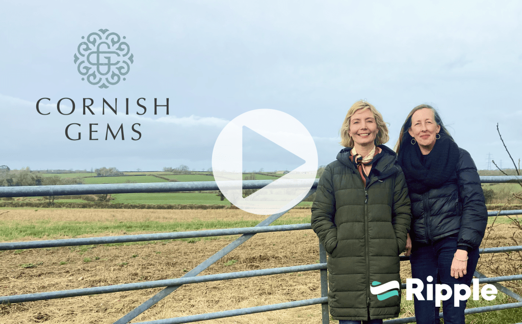 Cornish Gems standing at Derril Water Solar Park site with a play button to watch the video